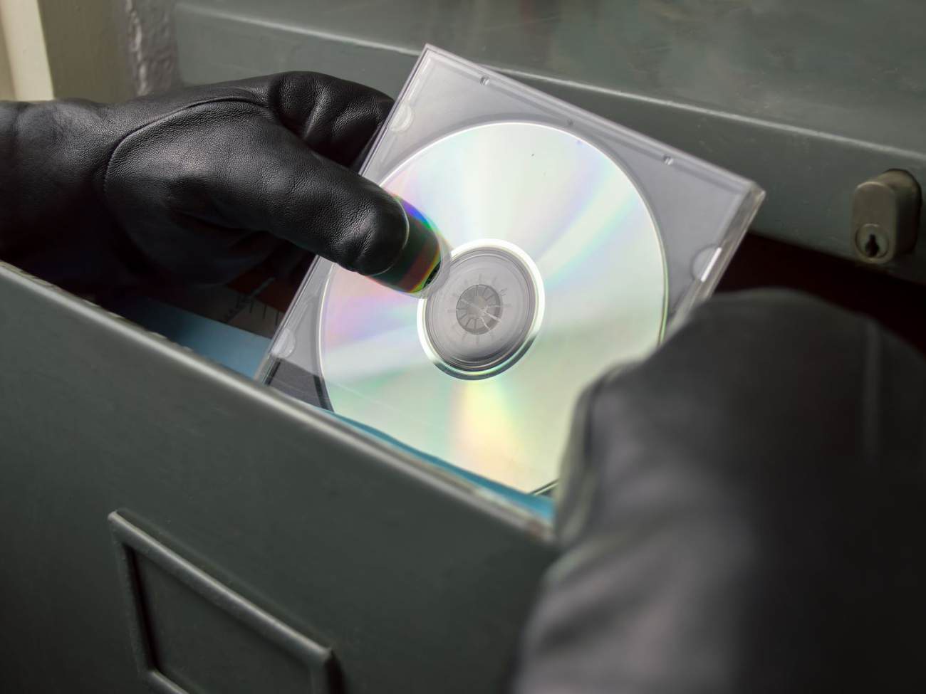 Dieb stiehlt eine CD aus einem Aktenschrank